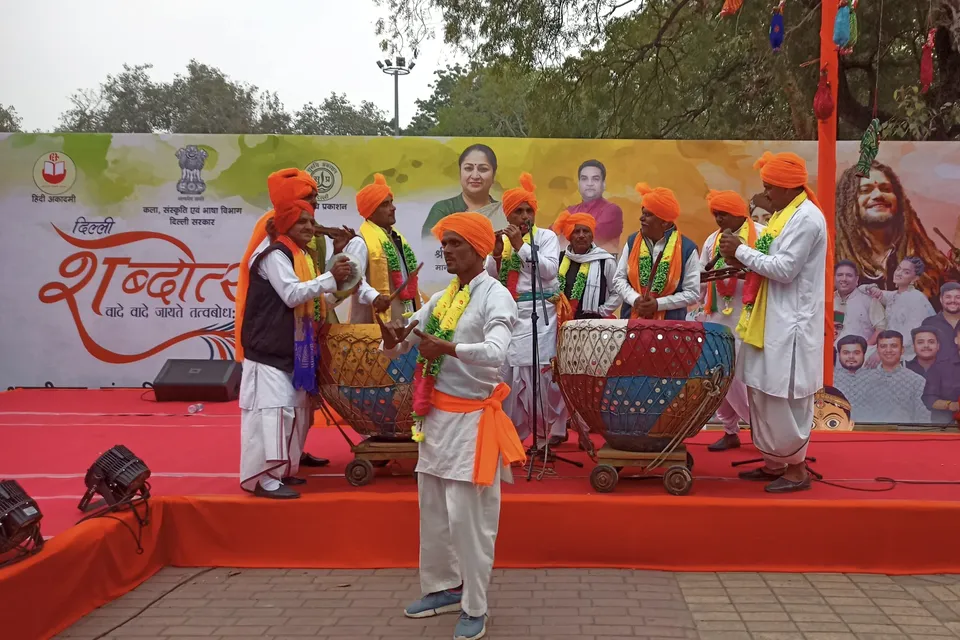 Folk musicians in turbans play dhol and drums on the Shabdotsav stage