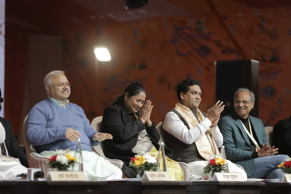 Dignitaries applaud from the stage during a session