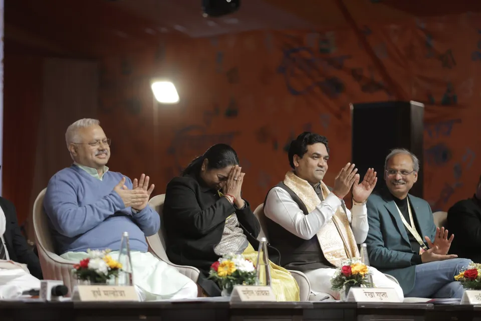 Dignitaries applaud from the stage during a session