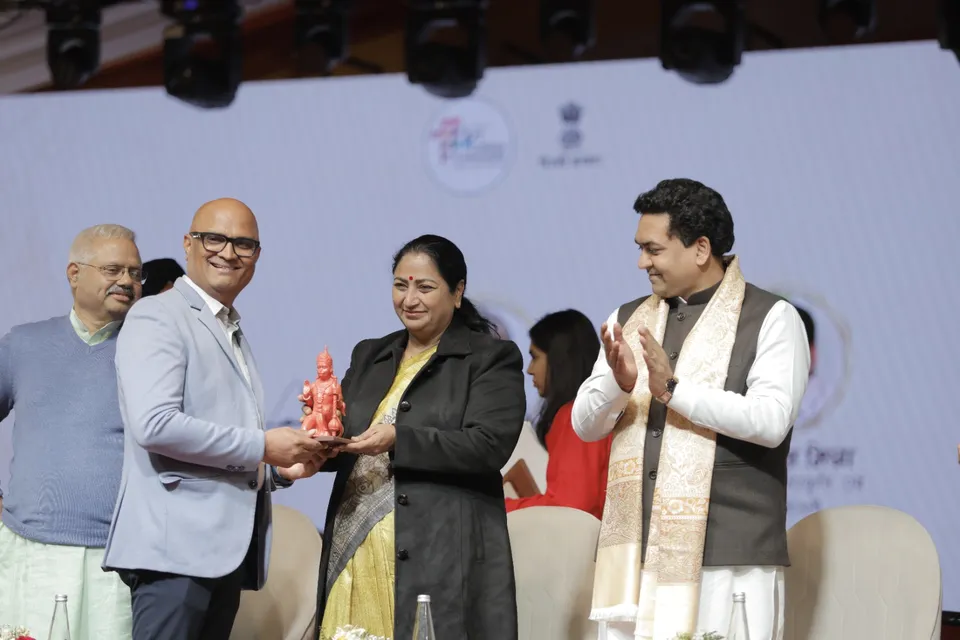 A memento is presented to a guest on the main stage