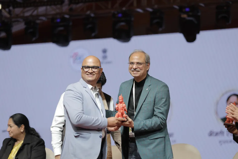 A memento is presented to a guest on the main stage