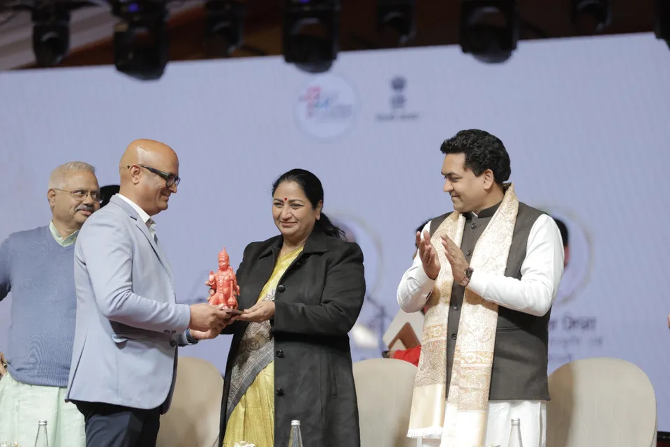 A memento is presented to a guest on the main stage
