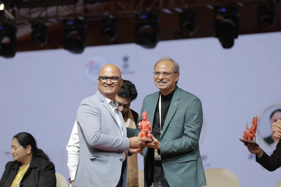 Guests and organisers on stage after a felicitation