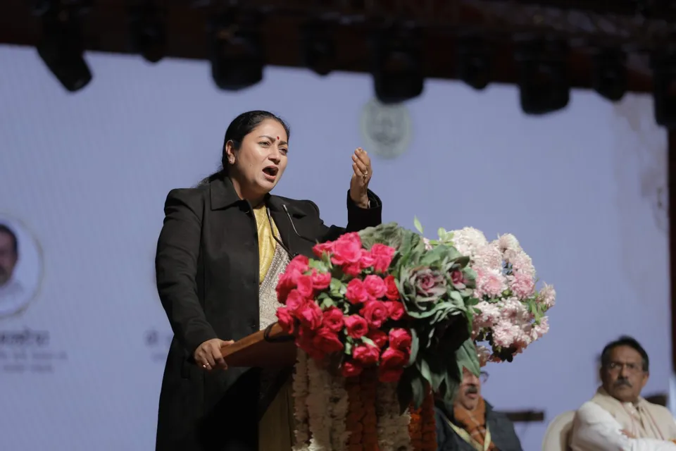 A speaker addresses the audience from the lectern on the main stage