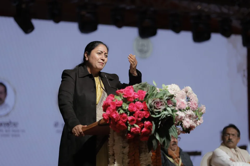 A speaker addresses the audience from the lectern on the main stage