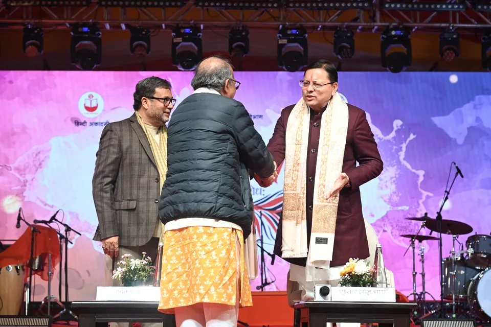 A guest is felicitated with a shawl on stage
