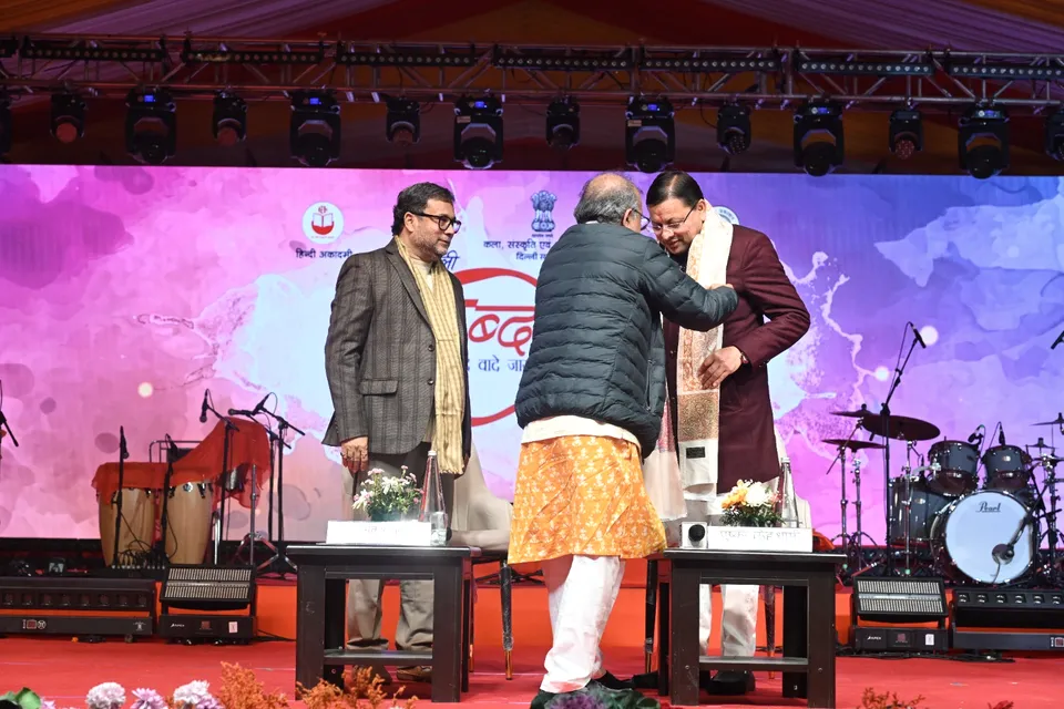 A guest is felicitated with a shawl on stage