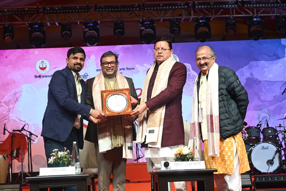 Guests pose with a memento on stage