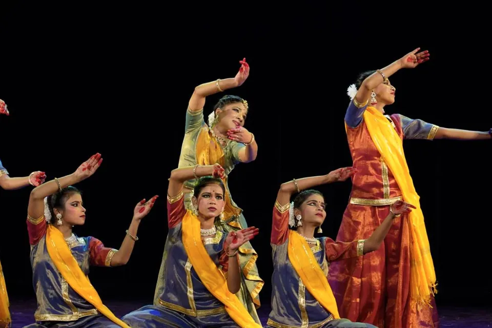 Group classical dance with yellow dupattas