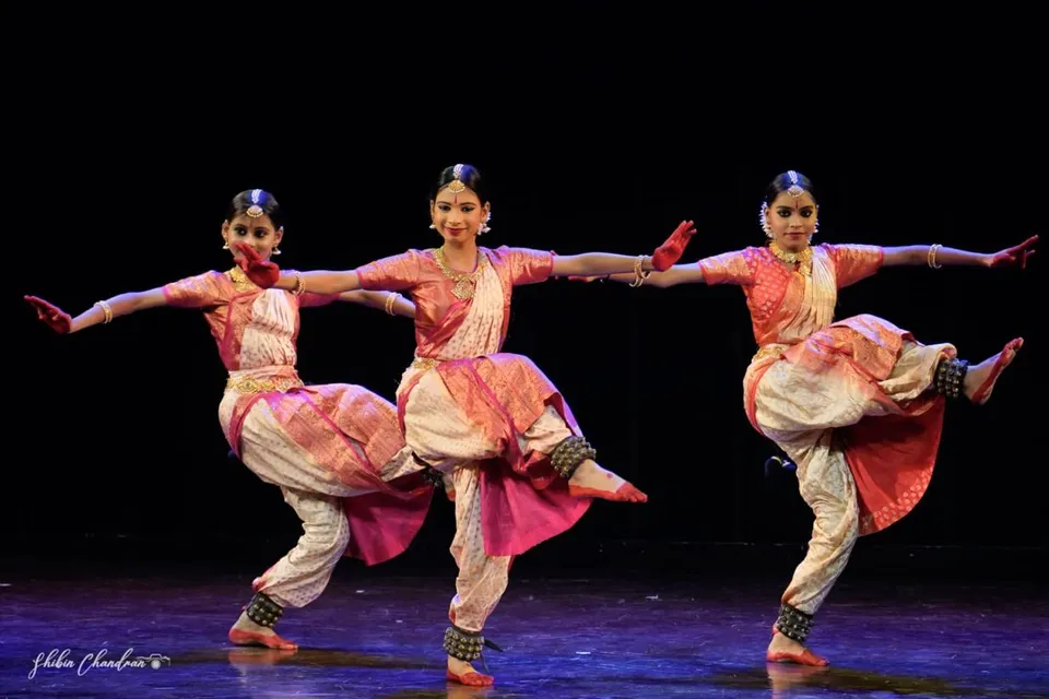 Dancers leap in unison
