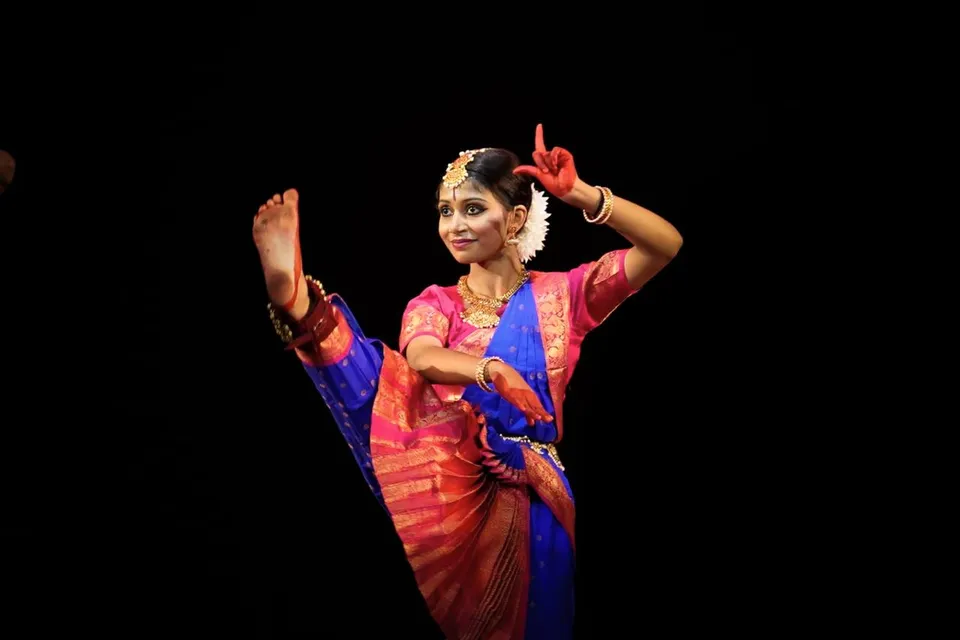 A Bharatanatyam dancer with raised hands